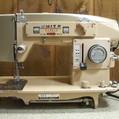 Front view of tan-colored vintage white 970 sewing machine